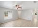 Open living space with tile flooring, ceiling fan, and natural light from the windows at 1051 Arden St, Longwood, FL 32750