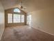 Bright living room with vaulted ceiling, large windows, and sliding glass door to the balcony at 1081 S Hiawassee Rd # 726, Orlando, FL 32835