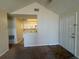 Living room featuring vaulted ceiling, view into kitchen, neutral walls and carpeting, and a white front door at 1081 S Hiawassee Rd # 726, Orlando, FL 32835