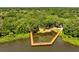 Aerial view of a community with a large wooden dock extending into a lake, surrounded by dense trees at 1121 Arbor Glen Cir, Winter Springs, FL 32708