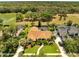 Aerial view of home with screened pool and mature trees, backing to a lake and green space at 1121 Arbor Glen Cir, Winter Springs, FL 32708