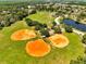 Aerial view of three baseball fields in a community park surrounded by trees and a pond at 1121 Arbor Glen Cir, Winter Springs, FL 32708