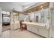 Spacious bathroom with double vanities, a makeup counter, and a view into the bedroom at 1121 Arbor Glen Cir, Winter Springs, FL 32708