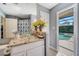 Bright bathroom features a glass vessel sink, granite countertop, and pool views at 1121 Arbor Glen Cir, Winter Springs, FL 32708