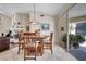 Cozy dining area with a wooden table, comfortable seating, and natural light from the nearby living room and sliding doors at 1121 Arbor Glen Cir, Winter Springs, FL 32708