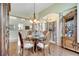Elegant dining room with wood floors and decorative columns creating an open and inviting space for entertaining at 1121 Arbor Glen Cir, Winter Springs, FL 32708