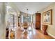 Formal dining room with hardwood floors, elegant furnishings, and a large window overlooking the backyard at 1121 Arbor Glen Cir, Winter Springs, FL 32708