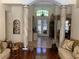 Elegant foyer with decorative columns, tile flooring, chandelier, and stained glass front doors at 1121 Arbor Glen Cir, Winter Springs, FL 32708
