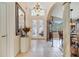 Grand foyer with tile flooring, chandelier, and a decorative mirror, leading to the dining and living areas at 1121 Arbor Glen Cir, Winter Springs, FL 32708