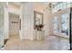 Spacious foyer with tile flooring, chandelier, decorative mirror, and views into other rooms of the house at 1121 Arbor Glen Cir, Winter Springs, FL 32708