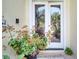 Close-up of the front door with stained glass and a decorative potted plant next to it at 1121 Arbor Glen Cir, Winter Springs, FL 32708