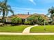 Beautiful home with lush landscaping, green lawn, and a winding walkway leading to the front door at 1121 Arbor Glen Cir, Winter Springs, FL 32708
