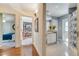 Hallway connecting a bathroom and bedroom, showcasing hardwood floors and neutral paint at 1121 Arbor Glen Cir, Winter Springs, FL 32708