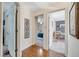 Hallway with wood flooring and doorways leading to bedrooms with neutral walls and carpet at 1121 Arbor Glen Cir, Winter Springs, FL 32708