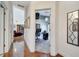 Hallway with wood floors leads to a well-lit office with a large desk and living area at 1121 Arbor Glen Cir, Winter Springs, FL 32708