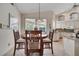 A charming kitchen dining area with views of the backyard, featuring an decorative hanging light fixture at 1121 Arbor Glen Cir, Winter Springs, FL 32708