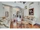 Open living room with hardwood floors, comfortable sofas, and decorative columns leading to the foyer at 1121 Arbor Glen Cir, Winter Springs, FL 32708