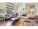 Bright living room with a fireplace, hardwood floors, large windows and comfortable seating at 1121 Arbor Glen Cir, Winter Springs, FL 32708