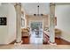 Bright living room with hardwood floors, decorative columns, large windows overlooking the pool, and comfortable seating at 1121 Arbor Glen Cir, Winter Springs, FL 32708