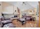 Open-concept living room with a fireplace, hardwood floors, and a view of the kitchen at 1121 Arbor Glen Cir, Winter Springs, FL 32708