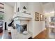 Bright living room with a fireplace, hardwood floors, decor and an open hallway at 1121 Arbor Glen Cir, Winter Springs, FL 32708