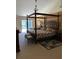 Spacious bedroom features a beautiful four-poster bed and a private balcony at 1121 Arbor Glen Cir, Winter Springs, FL 32708
