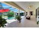 Relaxing outdoor screened living area featuring a ceiling fan, tiled floors, and a view of the backyard pool area at 1121 Arbor Glen Cir, Winter Springs, FL 32708