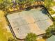 Aerial view of community pickleball court, fenced and surrounded by mature trees, offers a great recreational space at 1121 Arbor Glen Cir, Winter Springs, FL 32708