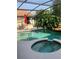 Relaxing pool and spa area with lush landscaping and a screened enclosure at 1121 Arbor Glen Cir, Winter Springs, FL 32708