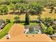Aerial view of home, roof, large screened in pool, lush green yard, and landscaping at 1121 Arbor Glen Cir, Winter Springs, FL 32708