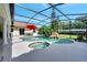 Gorgeous screened-in pool area with a rock waterfall feature, spa, and covered patio with outdoor seating at 1121 Arbor Glen Cir, Winter Springs, FL 32708