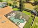 Aerial view showcasing a large, screened-in pool with lush landscaping and outdoor seating at 1121 Arbor Glen Cir, Winter Springs, FL 32708