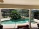 Covered patio with view of pool, rock waterfall and outdoor living at 1121 Arbor Glen Cir, Winter Springs, FL 32708