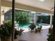 Screened-in pool area with mature landscaping and an adjacent patio for outdoor relaxation at 1121 Arbor Glen Cir, Winter Springs, FL 32708