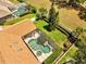 Aerial view of home, roof, large screened in pool, lush green yard, and landscaping at 1121 Arbor Glen Cir, Winter Springs, FL 32708