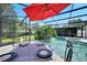 The enclosed pool area features a beautiful patio table set with dinnerware and a clear view of the swimming pool at 1121 Arbor Glen Cir, Winter Springs, FL 32708