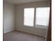 Bedroom featuring neutral carpet, fresh paint, and natural light from two windows at 1264 Blue Island Dr, Clermont, FL 34714