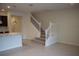 Open-concept living area with granite counters and a staircase with white railings at 1264 Blue Island Dr, Clermont, FL 34714