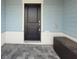 Home's front door offers a black door and covered porch with stone pavers at 1264 Blue Island Dr, Clermont, FL 34714