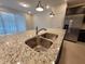 The spacious kitchen island features granite countertops and stainless steel appliances at 1264 Blue Island Dr, Clermont, FL 34714