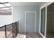 Covered patio features gray siding, brick pavers, and sliding glass door, leading to the backyard at 1264 Blue Island Dr, Clermont, FL 34714