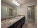 Bathroom featuring granite countertop with dual sinks and glass enclosed shower at 1286 Shoreside St, Clermont, FL 34714