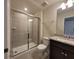 Well-lit bathroom featuring a vanity, toilet, and walk-in shower with glass doors at 1286 Shoreside St, Clermont, FL 34714