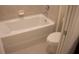 Clean, white bathroom with a bathtub and ceramic tile at 1286 Shoreside St, Clermont, FL 34714