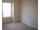 Bedroom featuring neutral carpet, white trim, and a window with blinds for privacy at 1286 Shoreside St, Clermont, FL 34714