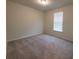 Bedroom with neutral carpet, beige walls and a window with blinds at 1286 Shoreside St, Clermont, FL 34714