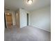 Inviting bedroom showcasing neutral carpet, a closet, and hallway access at 1286 Shoreside St, Clermont, FL 34714