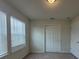 Bright and airy bedroom featuring neutral walls, carpet and closet and a window at 1286 Shoreside St, Clermont, FL 34714