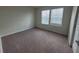Inviting carpeted bedroom featuring neutral walls, a large window and closet at 1286 Shoreside St, Clermont, FL 34714