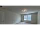 Bedroom features neutral carpet, walls, one window and single light fixture at 1286 Shoreside St, Clermont, FL 34714